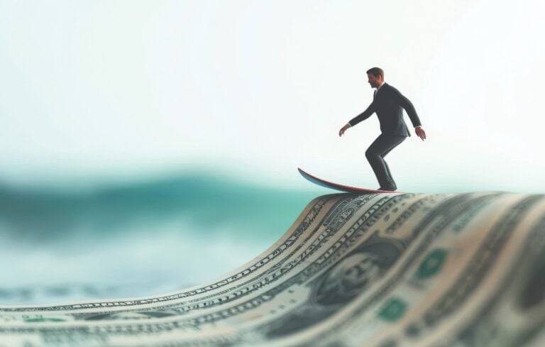 Businessman miniature surfing on a dollar bill wave