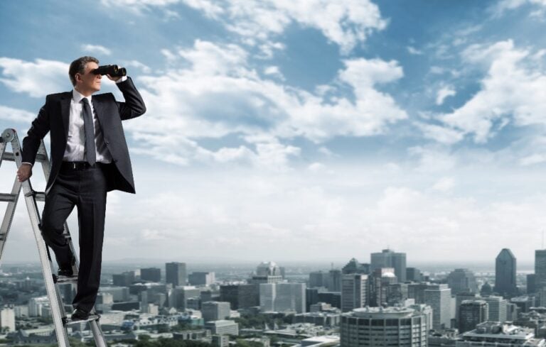 Man on ladder looking out with binoculars