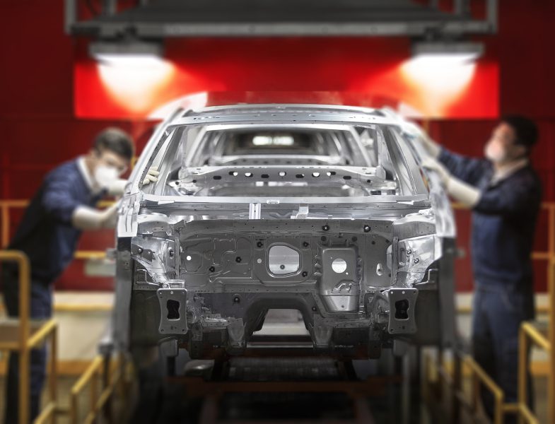 Workers constructing a car.